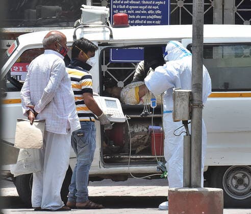 NEW DELHI, INDIA MAY 16: Health workers checking a person in an ambulance, before taking them into the Covid-19 ward at Lok Nayak Jai Prakash (LNJP) Hospital, on May 16, 2021 in New Delhi, India. (Photo by Raj K Raj Hindustan Times ) Daily Life Amid Coronavirus Pandemic In India