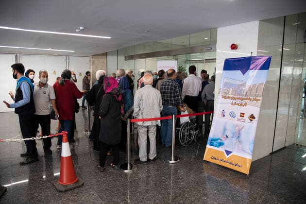 Iran: Vaccination of People over 75 years Iranian elderly people wearing protective face masks stay in a outdoor area while waiting to receive a dose of the new coronavirus disease (COVID-19) vaccine in Iranmall shopping complex in northwest of Tehran. Tehran Iran Iranmall Copyright: SobhanxFarajvan