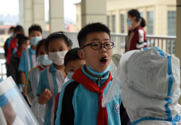 (210517) -- LU AN, May 17, 2021 -- A medical worker collects a swab sample of a student for nucleic acid testing at a primary school in Lu an, east China s Anhui Province, May 17, 2021. Lu an started to conduct a second round of nucleic acid testing for people in the city s main districts and in key areas from Monday to Wednesday, according to the commission. Authorities conducted the first round of testing from May 14 to 16 in the city proper, with more than 1 million samples collected. ) CHINA-ANHUI-LU AN-COVID-19-TEST (CN) ZhouxMu 