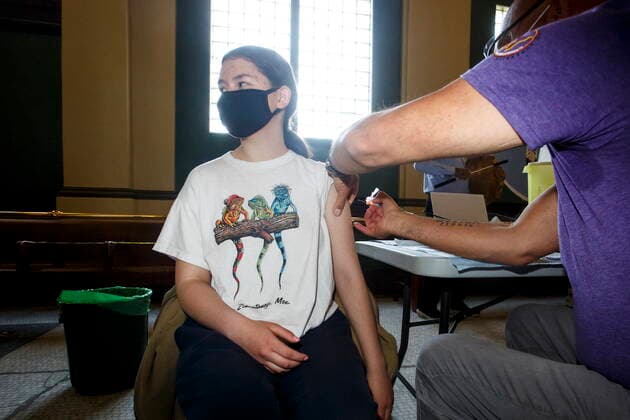 May 17, 2021, Winnipeg, mb, Canada: Dr. Barry Lavallee, CEO, Keewatinowi Inniniw Minoayawin, administers the Pfizer-BioNTech vaccine to Carley Hallett, 14, at the Aboriginal Health and Wellness Centre in Winnipeg, Monday, May 17, 2021. Winnipeg Canada - ZUMAc35_ 20210517_zaf_c35_011 Copyright: xMikexDealx