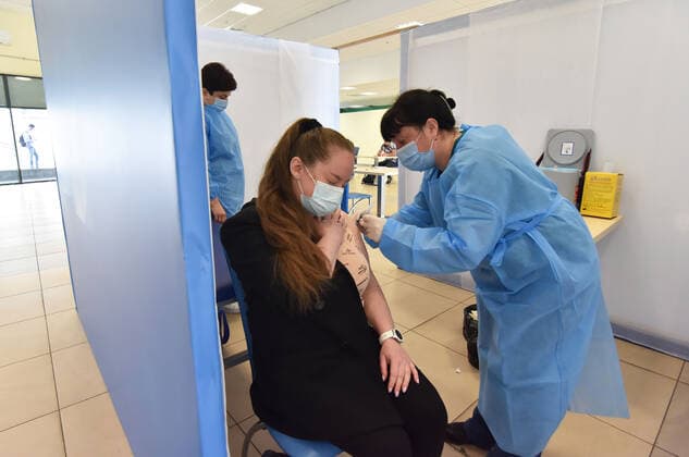 May 17, 2021, Lviv, Ukraine: A woman is given a dose of AstraZeneca Covid-19 vaccine by a health worker at a vaccination center..The city of Lviv in western Ukraine is offering the IT industry workers to be vaccinated with the AstraZeneca Covid-19 vaccine at a vaccination center located at the Arena Lviv stadium. Lviv Ukraine - ZUMAs197 20210517_zaa_s197_326 Copyright: xPavloxPalamarchukx