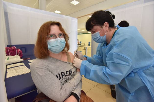 May 17, 2021, Lviv, Ukraine: A healthy worker injects a dose of AstraZeneca Covid-19 vaccine to a woman at a vaccination center..The city of Lviv in western Ukraine is offering the IT industry workers to be vaccinated with the AstraZeneca Covid-19 vaccine at a vaccination center located at the Arena Lviv stadium. Lviv Ukraine - ZUMAs197 20210517_zaa_s197_328 Copyright: xPavloxPalamarchukx