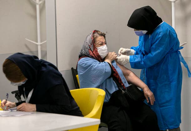 (210517) -- TEHRAN, May 17, 2021 -- A woman receives a dose of the COVID-19 vaccine at a vaccination site in Tehran, Iran, on May 17, 2021. Iran reported on Monday 14,319 new COVID-19 cases, raising the country s total number to 2,765,485. By Monday, 2,032,162 people have received the first doses of coronavirus vaccines and 388,821 the second doses. (Photo by Xinhua) IRAN-TEHRAN-COVID-19-VACCINATION AhmadxHalabisaz