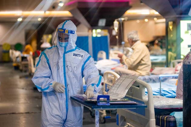 May 18, 2021, New Delhi, Delhi, India: A doctor wearing a Personal Protective Equipment suite (PPE) working inside of the Covid-19 Care Centre set up at Shehnai Banquet Hall attached to Lok Nayak covid-19 Hospital..Young doctors wearing Personal Protective Equipment suites (PPE) working inside the covid-19 care centre belongs to NGO Doctors For You . Covid-19 cases going down in Delhi, in last 24 hour Delhi recorded 4482 positive cases with 6.89 New Delhi India - ZUMAs197 20210518_zaa_s197_114 Copyright: xPradeepxGaurx
