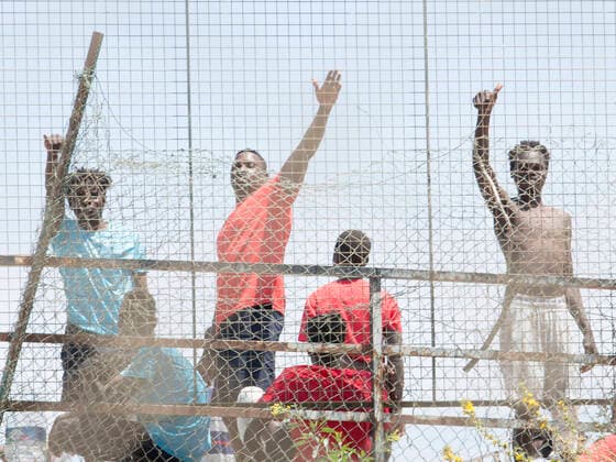Several migrants behind a fence at the Ciudad del Altos del Real football stadium on May 18, 2021, in Melilla, Spain. A total of 86 migrants of sub-Saharan origin -- 85 men and one woman -- have entered Melilla on Tuesday along the southern seawall of the nearest coast that separates the Spanish city from Morocco, hours after thousands of Moroccans entered Ceuta, in an action in which three civil guards and a woman have been injured by the aggressiveness shown by those who entered using stones. The migrants arrived today in Melilla have been transferred from the Temporary Stay Centre for Immigrants (CETI) to the Altos del Real Football City, where they are now. 18 MAY 2021;CEUTA;MIGRATION CRISIS;MELILLA;MOROCCO;SUB-SAHARAN Ãngela Rios L Copyright: xÃngelaxRiosx 3718725