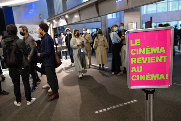 (210519) -- PARIS, May 19, 2021 -- People are seen at a reopened cinema in Paris, France, on May 19, 2021. France on Wednesday took an important step forward toward returning to normality as people in the country can once again meet up in cafes or enjoy a meal in restaurants, which are now allowed to open their terraces. Under the government s current plan to gradually relax the confinement measures, a maximum of six people per table are now allowed to be served on restaurant and cafe terraces. Museums, theaters, cinemas and sports facilities can now reopen to a maximum of 800 people indoors and 1,000 outdoors. (Photo by Xinhua) FRANCE-PARIS-COVID-19-REOPENING AurelienxMorissard 