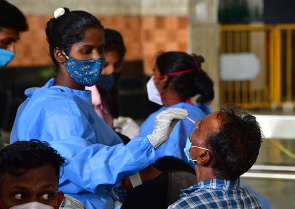 MUMBAI, INDIA - MAY 19: Healthcare workers wearing protective gear collect nasal samples of passengers for Covid test at CSMT station, on May 19, 2021 in Mumbai, India. (Photo by Bhushan Koyande Hindustan Times ) Medical Team Conducts COVID-19 Coronavirus Test