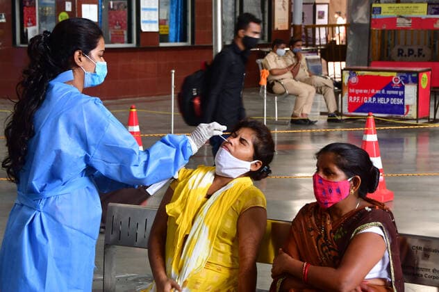 MUMBAI, INDIA - MAY 19: Healthcare workers wearing protective gear collect nasal samples of passengers for Covid test at CSMT station, on May 19, 2021 in Mumbai, India. (Photo by Bhushan Koyande Hindustan Times ) Medical Team Conducts COVID-19 Coronavirus Test