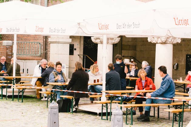 Outdoor Dinning Opens In Duesseldorf people enjoys beer at Uerige, a popular beer house in Duesseldorf, Germany on May 21, 2021 as Duesseldorf reopens the outdoor dinning to easing of coronavirus lockdown measures Duesseldorf Germany tang-notitle210521_np4Mh  Copyright: xYingxTangx