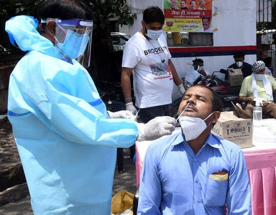 NEW DELHI, INDIA - MAY 21: A health worker takes a swab sample of a man, during a road-side test for Covid-19, at Kewal Park, on May 21, 2021 in New Delhi, India. ( Photo by Sonu Mehta Hindustan Times) Medical Team Conducts COVID-19 Coronavirus Test
