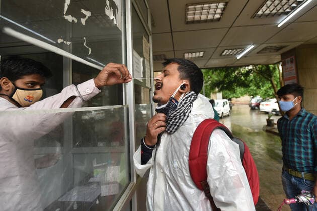 NOIDA, INDIA - MAY 21: A health worker collects a swab sample for Covid-19 test, at a district hospital at sector 30, on May 21, 2021 in Noida, India. (Photo by Sunil Ghosh Hindustan Times) Medical Team Conducts COVID-19 Coronavirus Test
