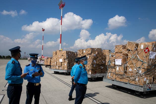 May 30, 2021, Kathmandu, Nepal: Nepal police officers stand on guard next to the boxes of essential medical supplies worth USD 8 Million to combat the ravaging COVID-19 crisis Support by the Switzerland Government seen after arriving at Tribhuvan International Airport..The government of Switzerland Supports 30-tonne shipment contains 40 Ventilators, Oxygen concentrators, 1.1 million rapid antigen test, and protective equipment (110000 KN95 Masks, 50000 gloves, and 15000 suits) Amounting to the value of USD 8 million to Nepal. Kathmandu Nepal - ZUMAs197 20210530_zaa_s197_004 Copyright: xPrabinxRanabhatx