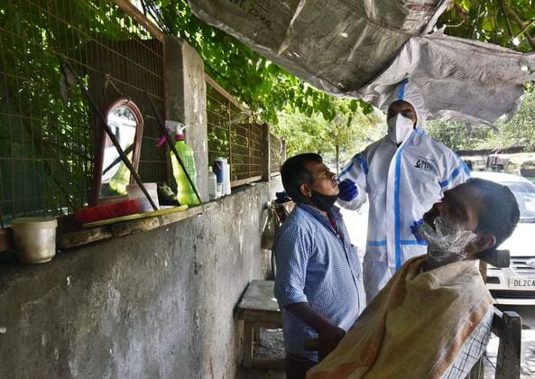 GURUGRAM, INDIA - MAY 22: A health worker in PPE collects a swab sample during a random Covid-19 testing drive at Kapahera, Delhi-Gurugram border, on May 22, 2021 in Gurugram, India. (Photo by Vipin Kumar Hindustan Times) Medical Team Conducts COVID-19 Coronavirus Test