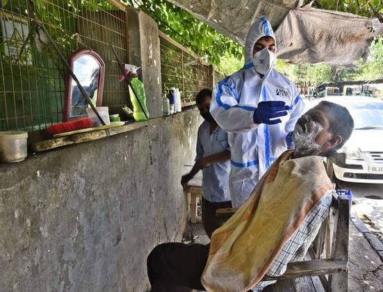 GURUGRAM, INDIA - MAY 22: A health worker in PPE collects a swab sample during a random Covid-19 testing drive at Kapahera, Delhi-Gurugram border, on May 22, 2021 in Gurugram, India. (Photo by Vipin Kumar Hindustan Times) Medical Team Conducts COVID-19 Coronavirus Test