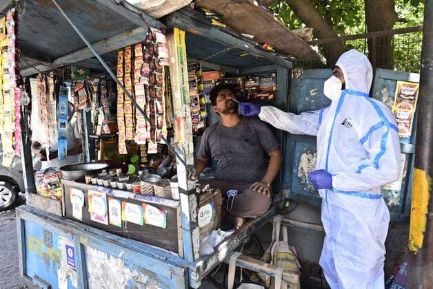 GURUGRAM, INDIA - MAY 22: A health worker in PPE collects a swab sample during a random Covid-19 testing drive at Kapahera, Delhi-Gurugram border, on May 22, 2021 in Gurugram, India. (Photo by Vipin Kumar Hindustan Times) Medical Team Conducts COVID-19 Coronavirus Test