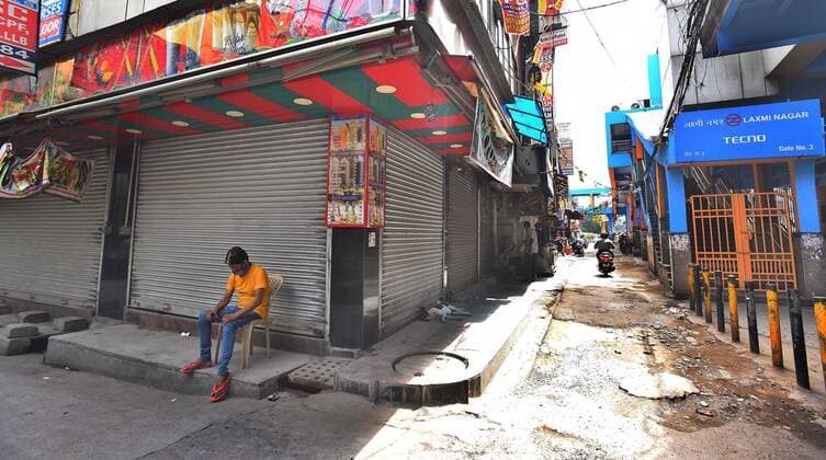 NEW DELHI, INDIA - MAY 23: A man sitting sits outside a closed shop during a Covid-19 induced lockdown, at Laxmi Nagar on May 23, 2021 in New Delhi, India. The lockdown in Delhi has been extended by another week and if the daily Covid numbers continue to drop, the process of unlocking will be initiated, Delhi Chief Minister Arvind Kejriwal said today. For now, the lockdown will be in place till 5 am on May 31. Delhi reported 1649 new cases of COVID on May 23. (Photo by Raj K Raj Hindustan Times) Lockdown In Delhi To Contain Spread Of Covid Pandemic