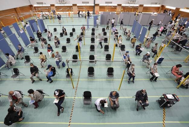 Mass vaccination center in Aichi Senior citizens wait to receive the Moderna coronavirus vaccine at Fujita Health University gymnasium, a newly opened mass vaccination center, in the Aichi Prefecture city of Toyoake, central Japan, on May 24, 2021. (No trimming allowed) 