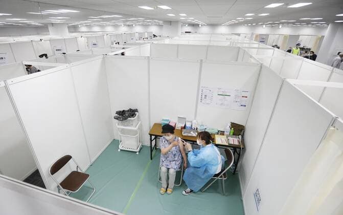 Large vaccination center in Sendai A senior citizen receives coronavirus vaccine at a newly opened large vaccination center near Sendai Station in Miyagi Prefecture, northeastern Japan, on May 24, 2021. 