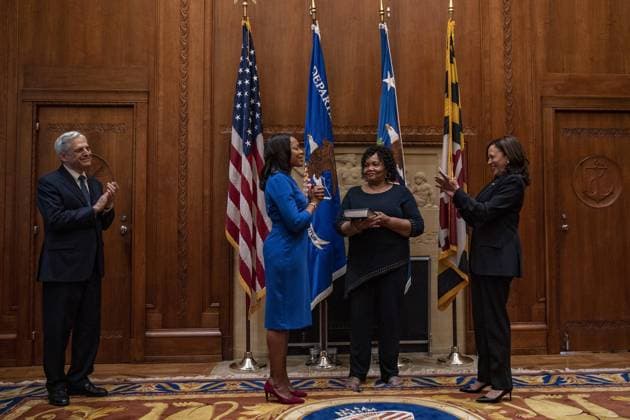 Kristen Clarke holds her hand up; as her mom Pansy Clarke holds a bible; as Vice President Kamala Harris swears her in at the Department of Justice in Washington, DC on Tuesday, May 25, 2021. Kristen Clarke was confirmed on Tuesday as the first black women to lead the Justice Departments Civil Rights Division.  WAP20210525032 TASOSxKATOPODIS