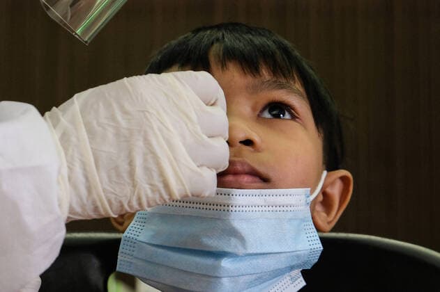 May 26, 2021, Sungai Buloh, Malaysia: A health worker wearing a personal protective equipment suit (PPE) is seen taking a nasal swab sample from a child during the COVID19 testing at a test center in Sungai Buloh..Malaysia has recorded the highest daily cases of Covid-19, yesterday with a record of 7,289 cases. Selangor government continues to conduct mass COVID19 screening tests over the state to battle the coronavirus pandemic. Sungai Buloh Malaysia - ZUMAs197 20210526_zaa_s197_013 Copyright: xFarisxHadziqx