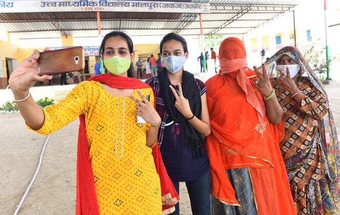 India: COVID-19 vaccination in Village of Rajasthan Rural beneficiaries take a selfie after receiving their first dose of COVID-19 vaccine at a vaccination centre in Malpura village near Beawar. India s prolonged and devastating wave of Covid-19 infections has gripped cities and overwhelmed urban health resources, but it has also reached deep into rural India, where the true extent of devastation is unknown because of the lack of widespread testing or reliable data. Beawar Rajasthan India Copyright: SumitxSaraswat