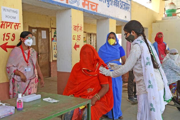 India: COVID-19 vaccination in Village of Rajasthan A medic administers a dose of COVID-19 vaccine to a rural woman in veil at a vaccination centre in Malpura village near Beawar. India s prolonged and devastating wave of Covid-19 infections has gripped cities and overwhelmed urban health resources, but it has also reached deep into rural India, where the true extent of devastation is unknown because of the lack of widespread testing or reliable data. Beawar Rajasthan India Copyright: SumitxSaraswat