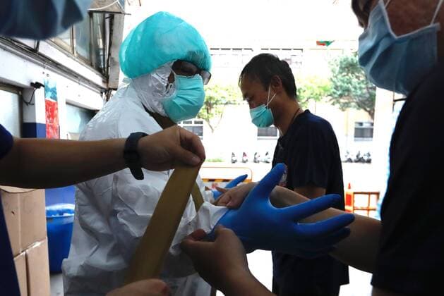 May 29, 2021, Taipei, Taipei, Taiwan: A special quarantine bus driver puts on a PPE at a fire station, where buses and taxis that carried quarantined persons are spread with disinfectant, before delivering citizens who have completed their quarantine, following a surge of domestic COVID-19 cases. The number of domestic COVID-19 cases particularly in Taipei has surged, with disinfection being intensified across the country to minimize transmission. Taipei Taiwan - ZUMAs313 20210529_zip_s313_019 Copyright: xDanielxCengxShou-Yix