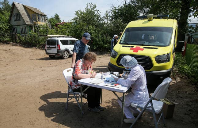 TATARSTAN, RUSSIA - MAY 29, 2021: Local people visit a mobile health unit to receive an injection of the Gam-COVID-Vac (Sputnik V) vaccine against COVID-19 on the premises of the Volga gardening partnership. Yegor Aleyev TASS  TS102049