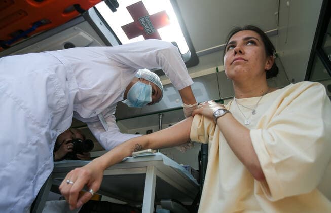 TATARSTAN, RUSSIA - MAY 29, 2021: A woman visits a mobile health unit to receive an injection of the Gam-COVID-Vac (Sputnik V) vaccine against COVID-19 on the premises of the Volga gardening partnership. Yegor Aleyev TASS  TS10204D
