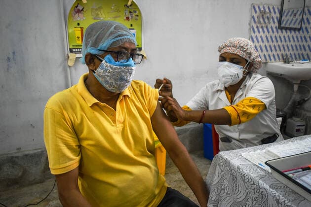 India: Covid-19 vaccination in Kolkata A person receives a dose of Covishield (Covid-19 vaccine) inside a West Bengal state Health Vaccination centre in Kolkata. Kolkata West Bengal India Copyright: SudiptaxDas