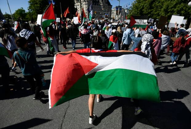 May 29, 2021, Ottawa, on, Canada: The flag of Palestine is waved behind a person during a rally in Ottawa to denounce Israel s military actions in the Palestinian territories, on Saturday, May 29, 2021. Ottawa Canada  - ZUMAc35_ 20210529_zaf_c35_013 Copyright: xJustinxTangx