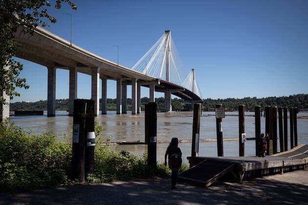 May 29, 2021, Coquitlam, BC, Canada: A woman takes in the view of the Fraser River under the Port Mann Bridge after Indigenous leaders held a ceremony to pray for the safety of the salmon, ecosystems and cultural heritage that depend on the river, ahead of work being done to drill under it for the Trans Mountain pipeline expansion, in Coquitlam, B.C., on Saturday, May 29, 2021. Coquitlam Canada  - ZUMAc35_ 20210529_zaf_c35_046 Copyright: xDarrylxDyckx