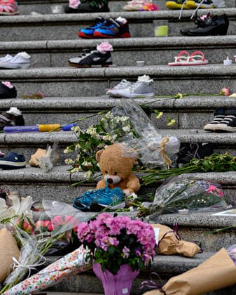 (210531) -- VANCOUVER, May 31, 2021 -- Children s shoes and toys are placed on the staircase outside Vancouver Art Gallery during a memorial event for the 215 children whose remains have been found buried at a former Kamloops residential school in Vancouver, British Columbia, Canada, May 30, 2021. (Photo by Xinhua) CANADA-VANCOUVER-KAMLOOPS INDIGENOUS SCHOOL-CHILDREN REMAINS-MEMORIAL AndrewxSoong 