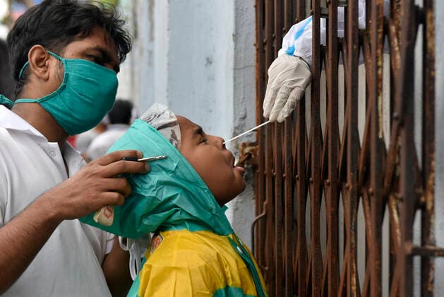 Coronavirus Emergency In Kolkata A child reacts as the health worker puts a cotton swab inside his mouth for a Covid-19 test in a government health centre in Kolkata, India, 31 May, 2021. Kolkata India aditya-notitle210531_np4zY  Copyright: xIndranilxAdityax