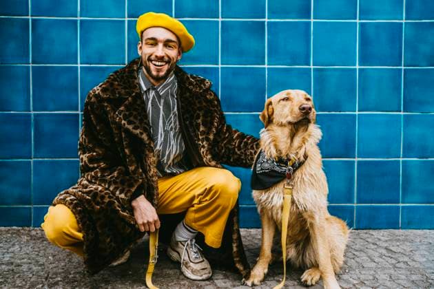 Full length of smiling man crouching by dog against blue tiled wall Berlin, Germany, model released Copyright: xMaskotx , MA86618