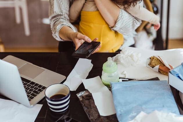 IMAGO Creative: Resilienz Midsection of female entrepreneur with male toddler photographing financial bills while working at home office Sweden, Stockholm, model released, property released Copyright: xMaskotx , MA86904