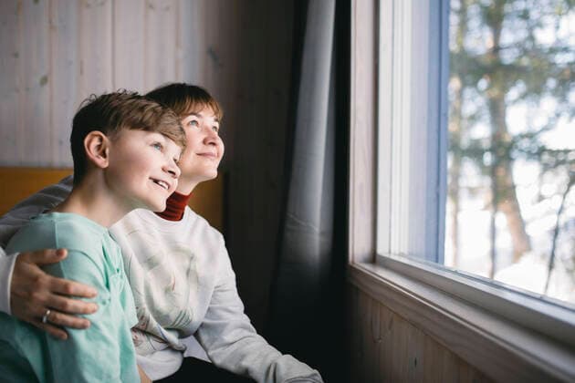 Happy mother and son sitting together while looking through window Sweden, Kiruna, model released Copyright: xMaskotx , MA86994