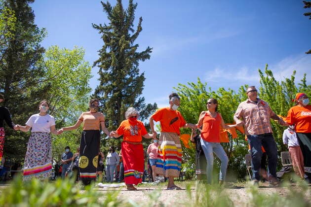 June 1, 2021, Muskowekwan First Nation, SK, Canada: Attendees perform a round dance during a press conference and prayer vigil at the former Muscowequan Indian Residential School, one of the last residential schools to close its doors in Canada in 1997 and the last fully intact residential school still standing in Saskatchewan at Muskowekwan First Nation, Sask., on Tuesday, June 1, 2021. The vigil was in response to the remains of 215 children recently found at the Kamloops Indian Residential School. Muskowekwan First Nation Canada  - ZUMAc35_ 20210601_zaf_c35_082 Copyright: xKaylexNeisx
