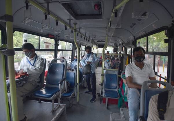 NEW DELHI, INDIA - JUNE 1: People sit inside a DTC bus at a bus stand at ISBT on June 1, 2021 in New Delhi, India. As due to Covid relaxations Metro services are yet not opened and DTC buses operating at 50% occupancy, daily commuters are facing problem. (Photo by Sonu Mehta Hindustan Times) Bus Passengers Face Difficulty In Delhi Due To Covid Restrictions