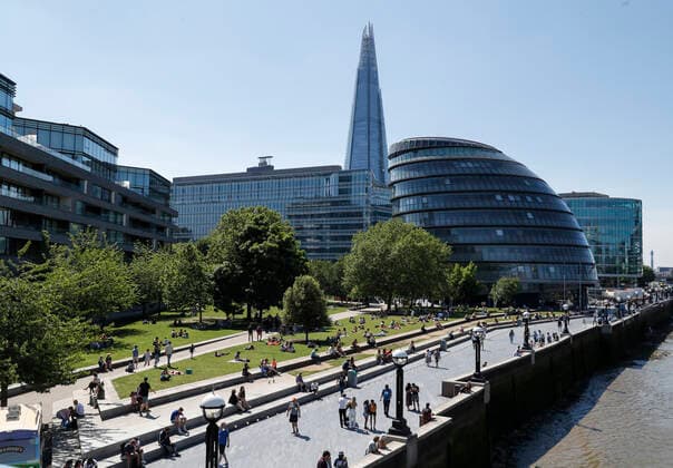 (210602) -- LONDON, June 2, 2021 -- People enjoy sunshine at Potters Field Park in front of the City Hall in London, Britain, June 1, 2021. Britain remains in a vulnerable position in fighting coronavirus despite the progress of the country s vaccination program, a scientist advising the British government said Tuesday. Professor Adam Finn from the Joint Committee on Vaccination and Immunisation, which advises the government on vaccine priority, said the job to contain the pandemic is not done as large numbers of people are still unvaccinated. ) BRITAIN-LONDON-COVID-19 HanxYan 