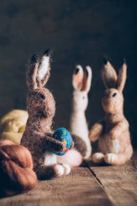Hand made easter rabbit made of wool and felt on dark wooden table, Property released Copyright: xRamonxLopezx Model Released