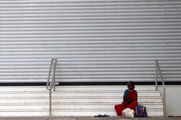 June 3, 2021, Chennai, Tamil Nadu, India: A woman seen sitting near a closed shops during the lockdown imposed as a preventive measure against the spread of the Covid-19 coronavirus in Chennai. Chennai India - ZUMAl172 20210603_zip_l172_005 Copyright: xSrixLoganathanx