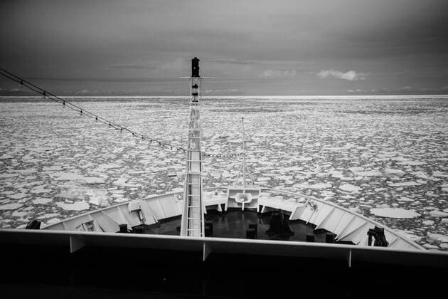 Cruise ship pushing through sea ice as it reaches the Antarctic Peninsula Copyright: xCatalinxMarinx