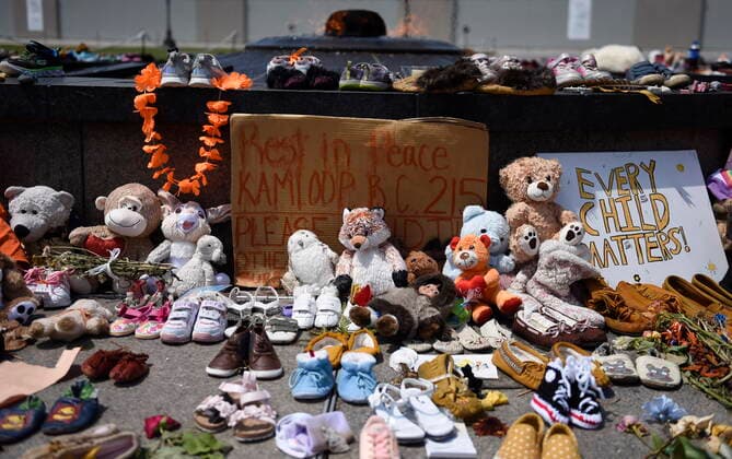 June 4, 2021, Ottawa, on, Canada: Shoes, stuffed animals, flowers and signs are left against the Centennial Flame at a memorial for the 215 children whose remains were found at the grounds of the former Kamloops Indian Residential School at Tkâ€⠢emlups te Secwo pemc First Nation in Kamloops, B.C., on Parliament Hill in Ottawa on Friday, June 4, 2021. Ottawa Canada - ZUMAc35_ 20210604_zaf_c35_041 Copyright: xJustinxTangx