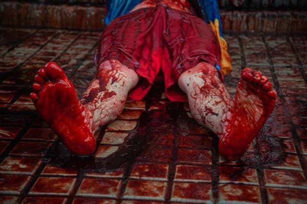 Demonstrators participate in a performance that resembles torture with fake blood in front of a Exito Supermarket after various videos viralized in social media showing a supermarket used to torture and detain demonstrators in the city of Cali, Colombia as thousands gathered to protest against the president of Colombia Ivan Duque Maraquez and the cases of unrest and police brutality that had left at least 45 dead during the first month of demonstrations, in Bogota, Colombia on May 28, 2021. ChepaxBeltran LongxVisualxPress 1059_02_CHP_PN28M_20210528017