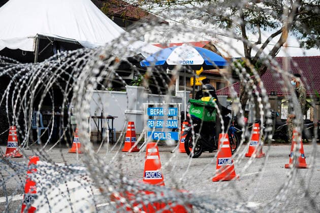 Kuala Lumpur 05 06 2021 .Police officers check vehicles at a roadblock to ensure that people abide by the movement control order in downtown Kuala Lumpur, Malaysia. Florent Mamelle HBLnetwork