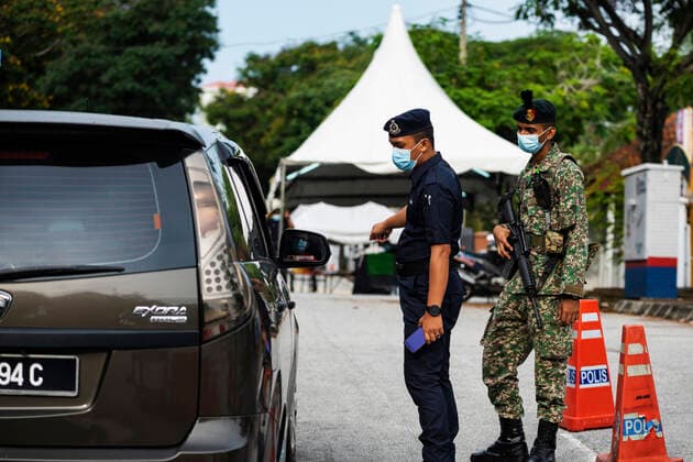 Kuala Lumpur 05 06 2021 .Police officers check vehicles at a roadblock to ensure that people abide by the movement control order in downtown Kuala Lumpur, Malaysia. Florent Mamelle HBLnetwork