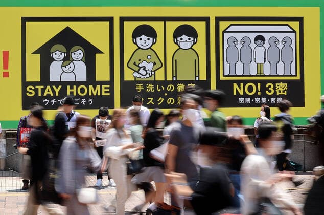 June 5, 2021, Tokyo, Japan - People walk in front of a large notice to avoid COVID-19 at Tokyo s Shibuya fashion district amid outbreak of the new coronavirus on Saturday, June 5, 2021.  (161857670)