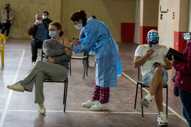 June 5, 2021, Firmat, Santa Fe, Argentina: Inside a makeshift vaccination center in a basketball court, a woman gets a shot of COVID-19 AstraZeneca vaccine. Firmat Argentina - ZUMAm105 20210605_zaf_m105_002 Copyright: xPatricioxMurphyx