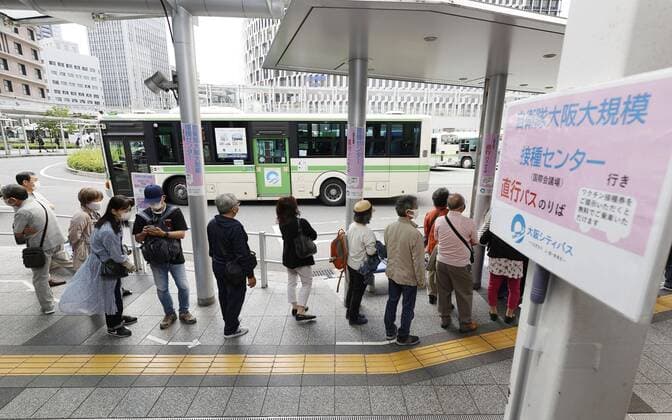 Mass vaccination center in Osaka People wait for a bus on a direct route between JR Osaka Station and a mass coronavirus vaccination center in the western Japan city on June 7, 2021. 